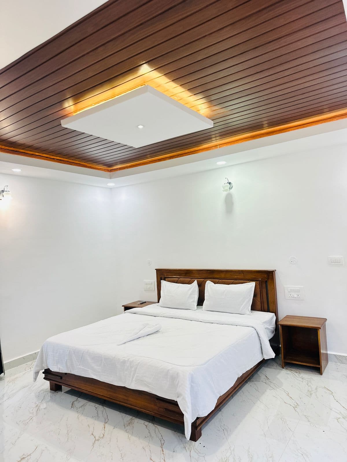 Master bedroom with warm wooden furnishings at Mistora Estate Villa
